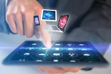 Composite image of businessman using digital tablet