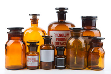 Vintage pharmacy bottles on white background