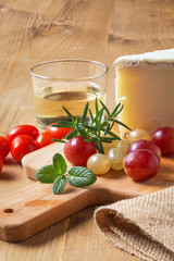 Close-up of grape,mint,rosemary,cheese and tomatoes