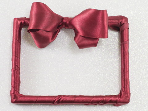 empty picture frame with red ribbon