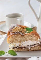 Cream cake with chocolate sauce and mint and coffee