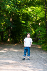 young boy standing outdoors in spring