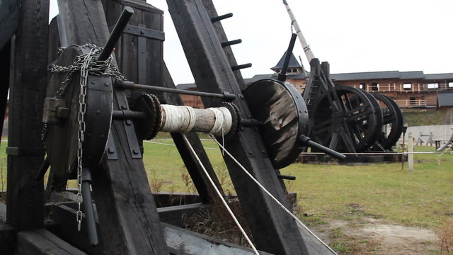 Medieval wooden catapult exhibits at open air history museum, military equipment