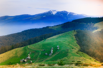 Landscape in the mountain:snowy tops and green valleys.