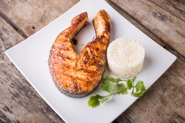 Roasted grill salmon steak with rice on white plate. Restaurant fish menu background