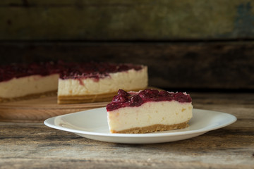 Wedge of cheesecake on wooden table. Homemade New-York-style cheese cake 