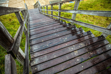 Old long wooden steps to beach of the North Sea.