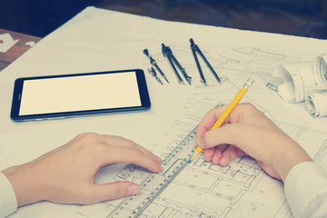 Architect working on blueprint. Architects workplace - architectural project, blueprints, ruler,...