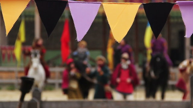 Defocused people in medieval clothes performing traditional dance, singing songs