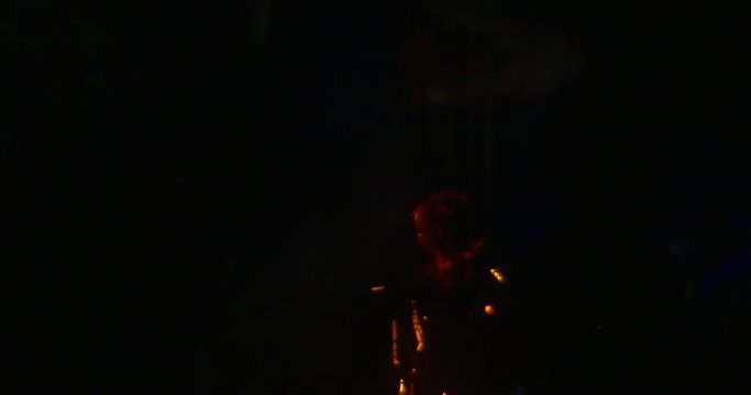 Silhouette of a Person Man is Making a Sparks Darkness Tapping a Fireless Torch Orange Sparks after Flame Smoke is Raising Up Night Outdoors