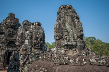 Fototapeta na wymiar Carved stone heads of Bayon temple, Angkor Wat, Cambodia