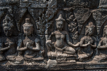 Carved stone figures on the wall at Bayon Temple, Angkor Wat, Cambodia