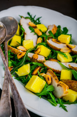 Chicken salad with mango, arugula, and peanuts