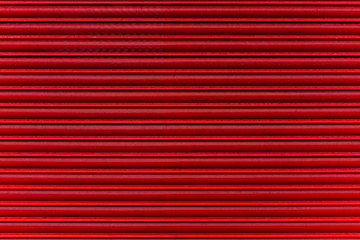 Red metal shutters protecting shop frontage