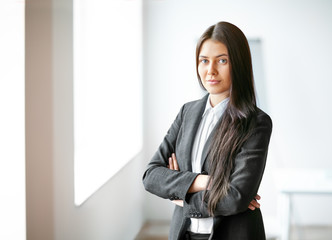 Portrait of young beautiful business woman in the office