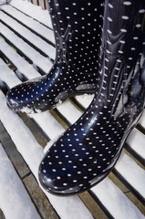 Black boots with polka dots in the snow