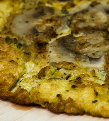 Omelette mushrooms on a wooden plate