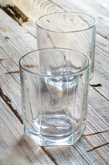 Two empty cocktail glasses on wooden table