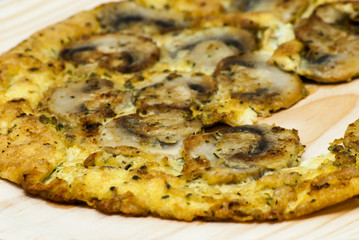 Omelette mushrooms on a wooden plate
