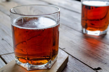 Two glass beer on wood background