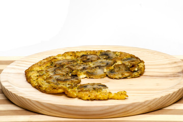 Omelette mushrooms on a wooden plate