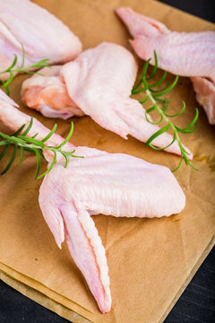 Raw chicken wings on wooden table