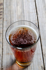 Glass beer on wood background with copyspace