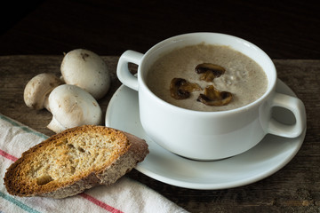 Bowl of mushroom soup puree with a few mushrooms