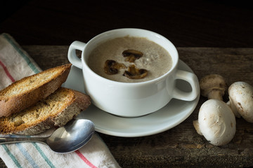 Bowl of mushroom soup puree with a few mushrooms