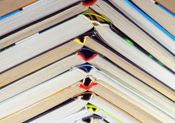 Fototapeta premium Open book lying on a shelf in the library