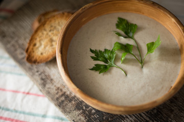 Mushroom soup puree in ceramic bowl with bread