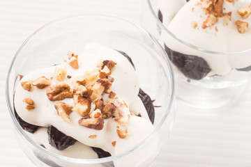 Dessert with prune, walnuts and whipped cream