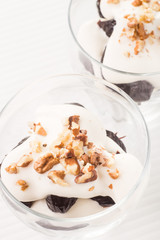 Dessert with prune, walnuts and whipped cream