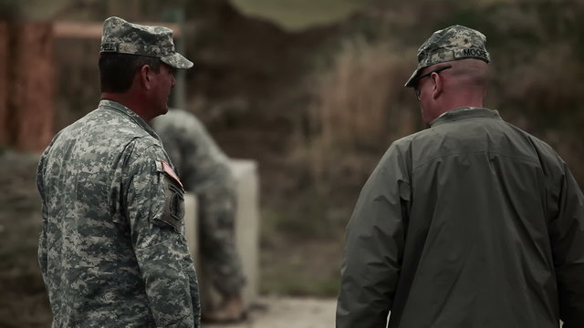 Range instructors talking at firing range