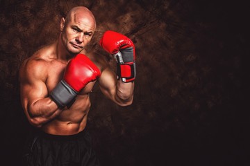 Composite image of portrait of boxer with red gloves