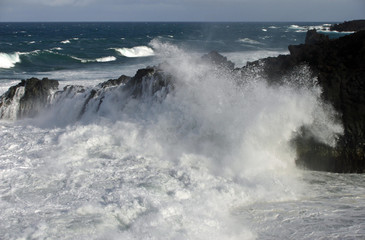 Waves crashing against cliffs
