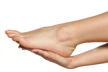 female hand holds the bare female foot