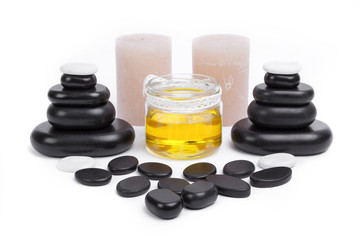 isolated massage stones set with candles and oil
