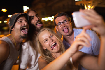 Young people taking crazy selfie with mobile