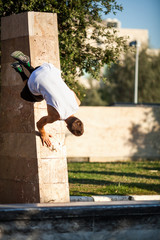 Young man performing parkour in the city