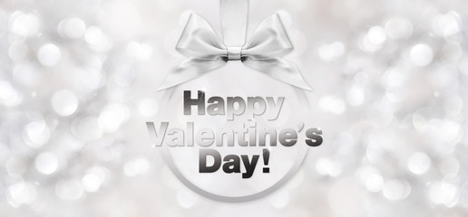 Obraz na płótnie Canvas happy valentines day text with shiny silver ribbon bow on blurre
