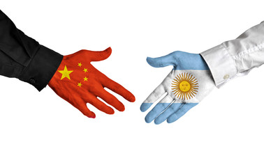 China and Argentina leaders shaking hands on a deal agreement