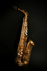 Fototapeta na wymiar Beautiful golden saxophone on black background