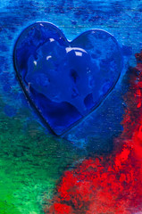 Three-dimensional hand-painted blue heart on colorful background. Gift for Valentine's Day.