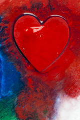 Three-dimensional hand-painted red heart on colorful background. Gift for Valentine's Day.