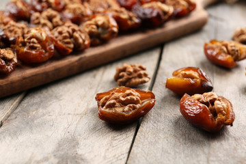 Walnut, date fruit on wooden table, close-up