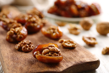 Walnut in date fruit on cutting board, close-up