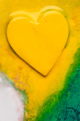 Three-dimensional hand-painted yellow on colorful background. Gift for Valentine's Day.