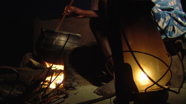 A woman stirring food in a pot in Africa.