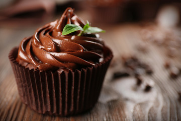 Chocolate cupcakes and coffee beans on wooden table